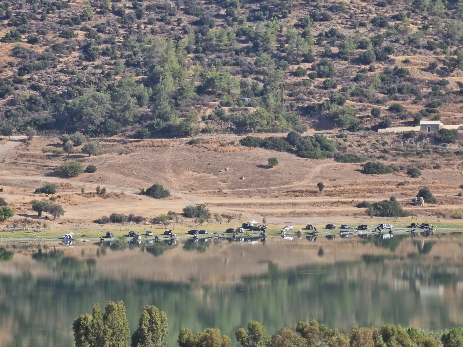 The Germasogeia reservoir, its calm water ringed by green hills